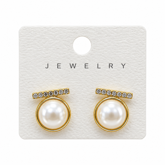 Round white pearl-style earrings with gold-tone rims and sparkling horizontal bars